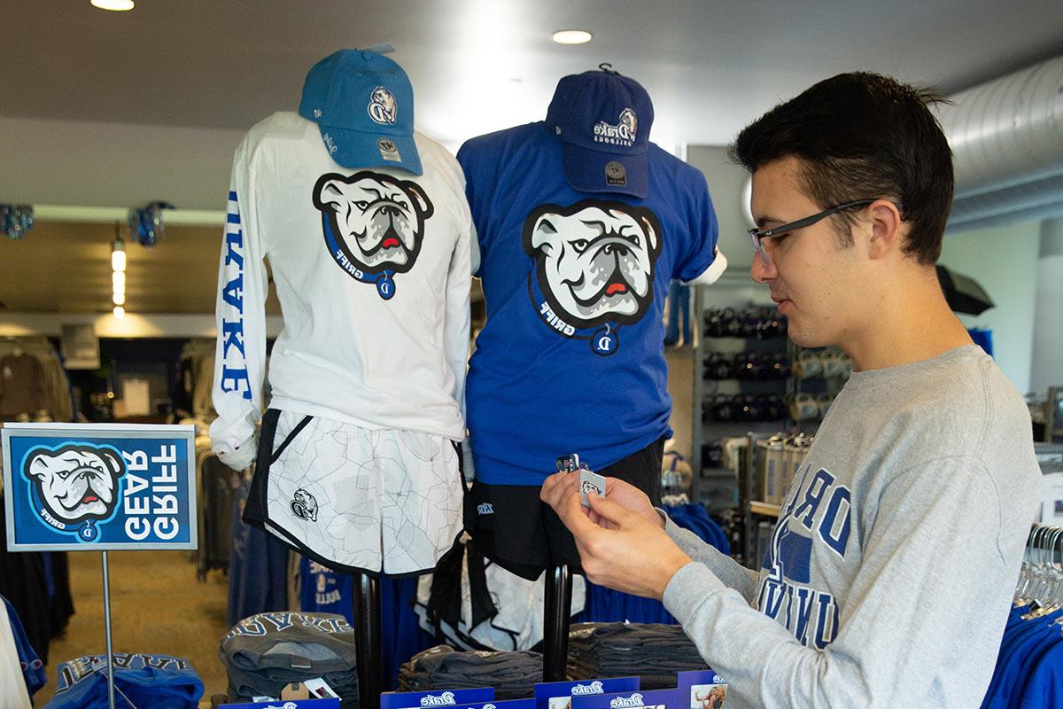 A student shopping for Griff Gear at the Drake bookstore on campus